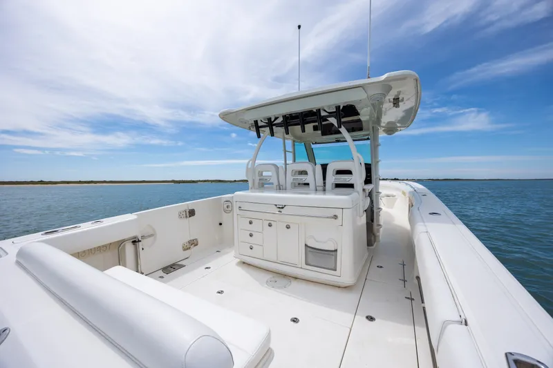Slide: The Image of 2017 Boston Whaler 370 Outrage boat interior on calm water under blue sky. - 22