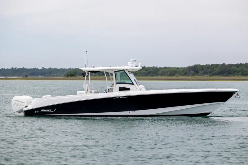 Slide: The Image of 2017 Boston Whaler 370 Outrage boat on calm water, side view. - 8