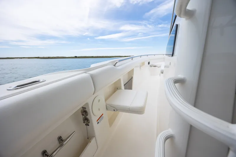 Slide: The Image of 2017 Boston Whaler 370 Outrage boat deck with white seating and ocean view. - 33