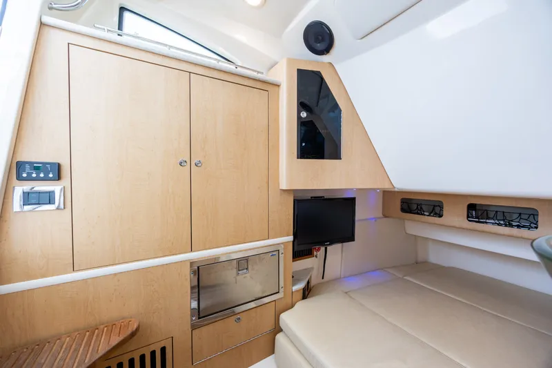 Slide: The Image of Interior cabin of 2017 Boston Whaler 370 Outrage with wood cabinetry and seating. - 46