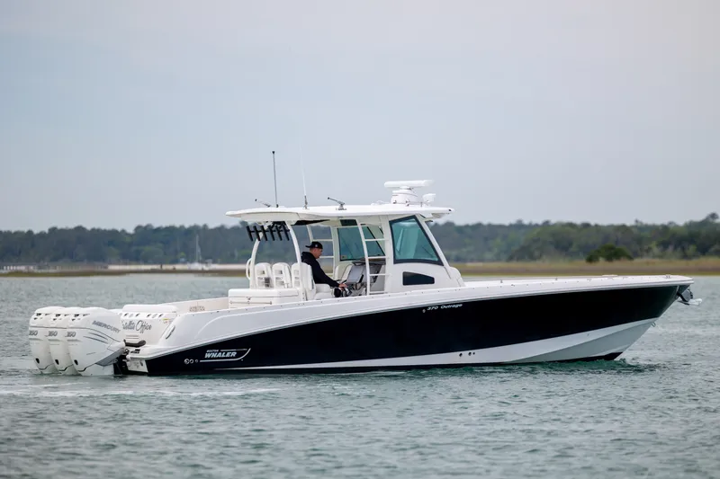 Slide: The Image of 2017 Boston Whaler 370 Outrage boat cruising on water with triple engines. - 6