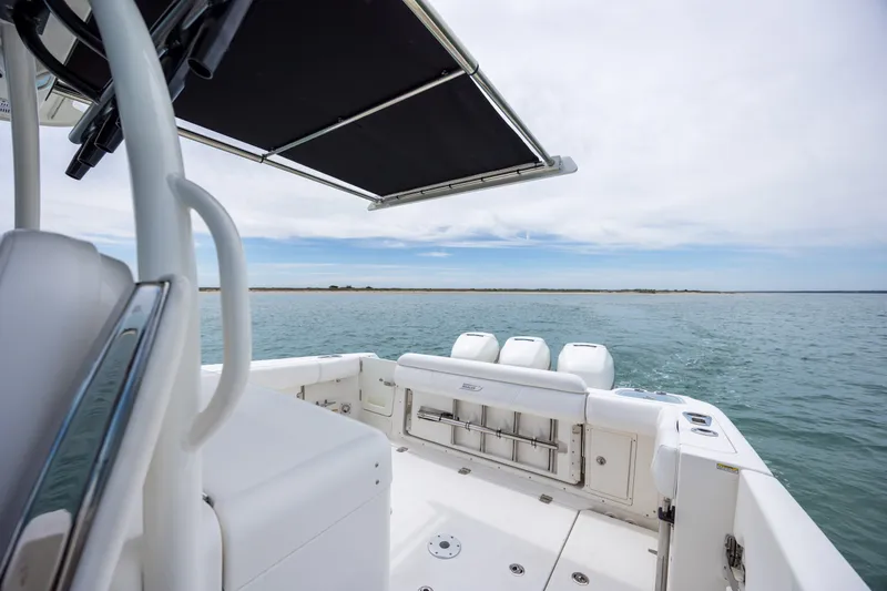 Slide: The Image of 2017 Boston Whaler 370 Outrage on open water, showcasing sleek design and powerful engines. - 26