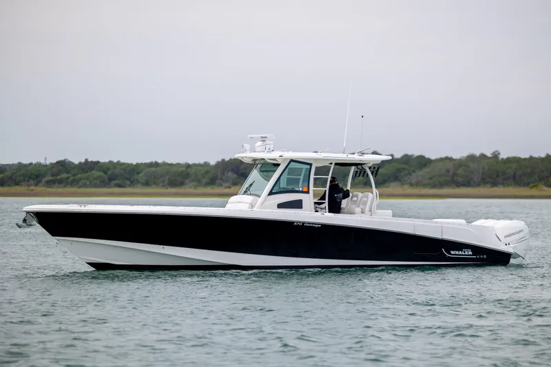 Slide: The Image of 2017 Boston Whaler 370 Outrage boat cruising on calm waters. - 1
