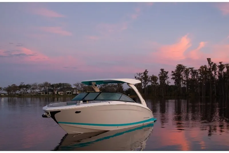 The Image of 2027 Regal LS9 boat on serene lake at sunset with pink sky. - 1
