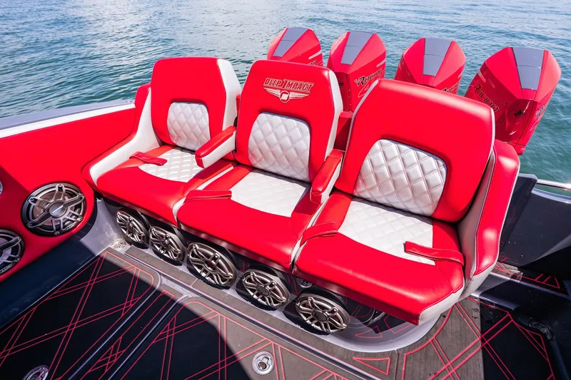 Slide: The Image of Red and white seating on 2022 Deep Impact 399 Sport boat, featuring stylish design and powerful engines. - 68