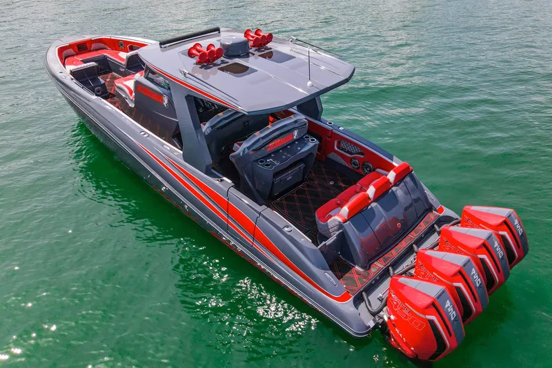 Slide: The Image of 2022 Deep Impact 399 Sport boat with red accents and four powerful engines on green water. - 14