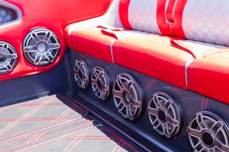 Slide: The Image of Red and white seating with multiple speakers on a 2022 Deep Impact 399 Sport boat. - 76