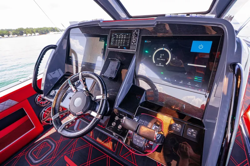Slide: The Image of Cockpit of 2022 Deep Impact 399 Sport boat with advanced navigation displays and controls. - 51
