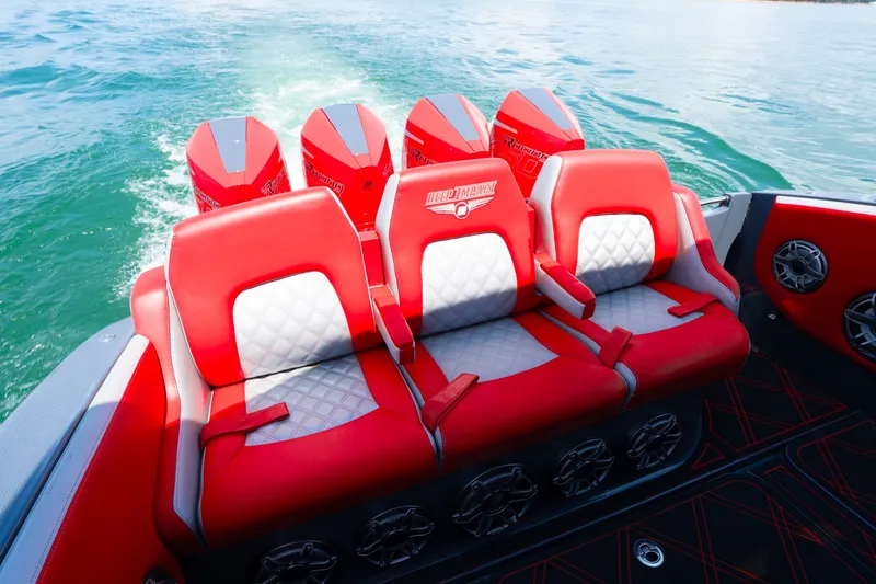 Slide: The Image of 2022 Deep Impact 399 Sport boat with red and white seating and powerful engines. - 71