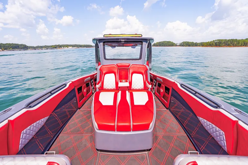 Slide: The Image of 2022 Deep Impact 399 Sport boat with red and white seating on a calm lake. - 34