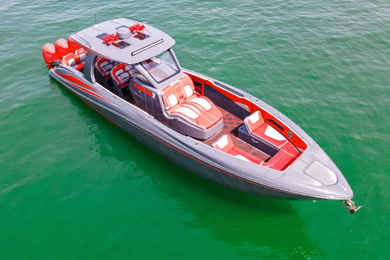 Slide: The Image of 2022 Deep Impact 399 Sport boat with red and gray design on clear water. - 22