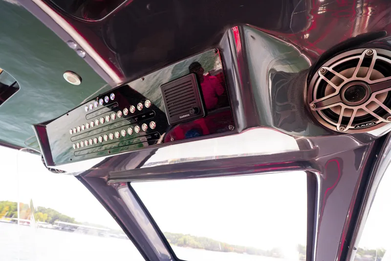 Slide: The Image of Control panel and speaker on 2022 Deep Impact 399 Sport boat. - 52