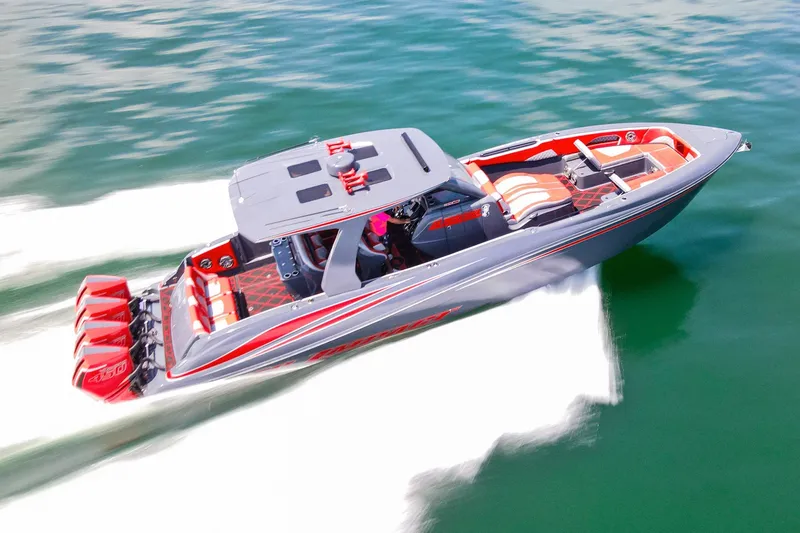 Slide: The Image of 2022 Deep Impact 399 Sport boat speeding on water with vibrant red accents. - 94