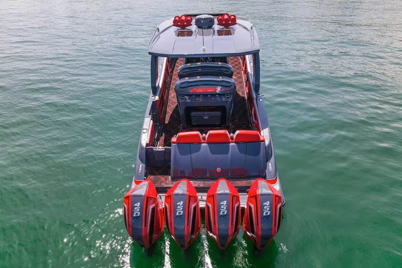 Slide: The Image of 2022 Deep Impact 399 Sport boat with four powerful outboard engines on water. - 15