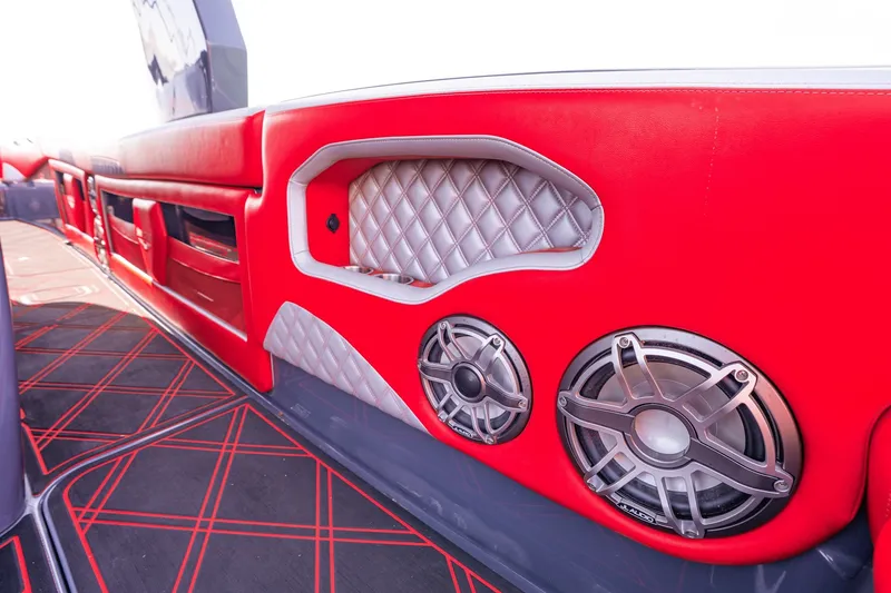 Slide: The Image of Interior of 2022 Deep Impact 399 Sport boat with red upholstery and speakers. - 77