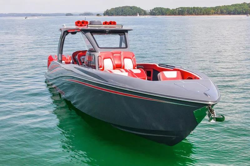 Slide: The Image of 2022 Deep Impact 399 Sport boat with sleek design and red accents on calm water. - 17