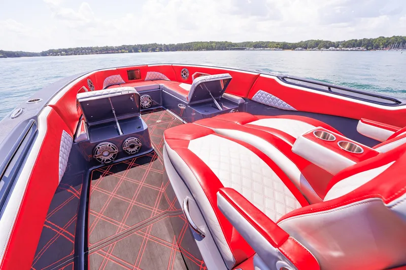 Slide: The Image of Luxurious 2022 Deep Impact 399 Sport boat interior with red and white seating on a sunny day. - 29