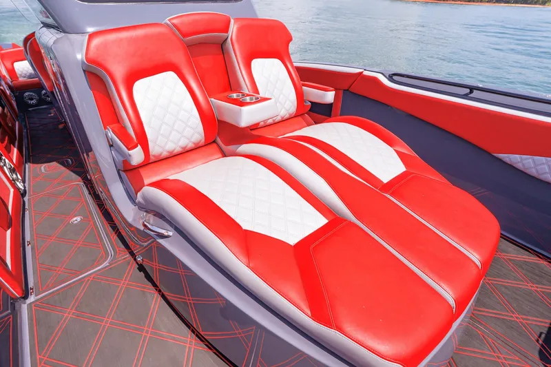 Slide: The Image of Luxurious red and white seating on 2022 Deep Impact 399 Sport boat, featuring sleek design. - 36