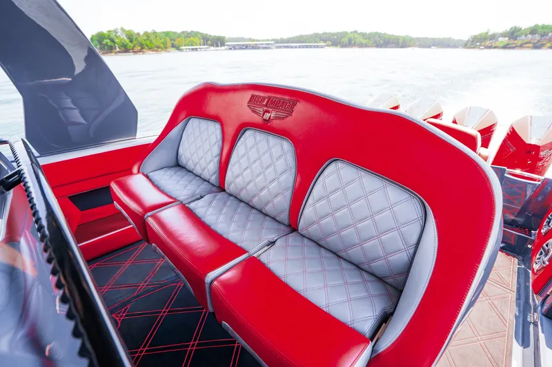 Slide: The Image of Red and gray seating on 2022 Deep Impact 399 Sport boat, with scenic water view. - 63