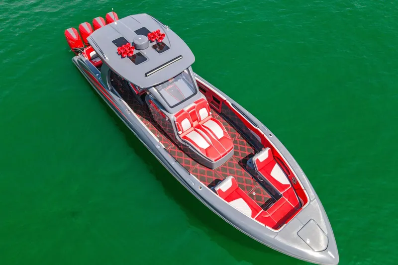 Slide: The Image of 2022 Deep Impact 399 Sport boat with red and gray design on green water. - 26