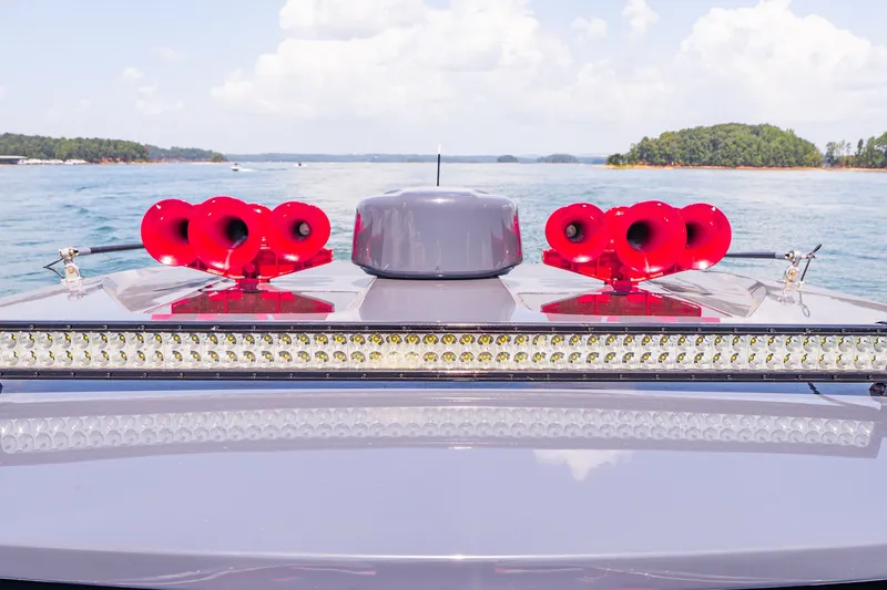 Slide: The Image of 2022 Deep Impact 399 Sport boat with red horns and LED lights on a sunny day. - 75