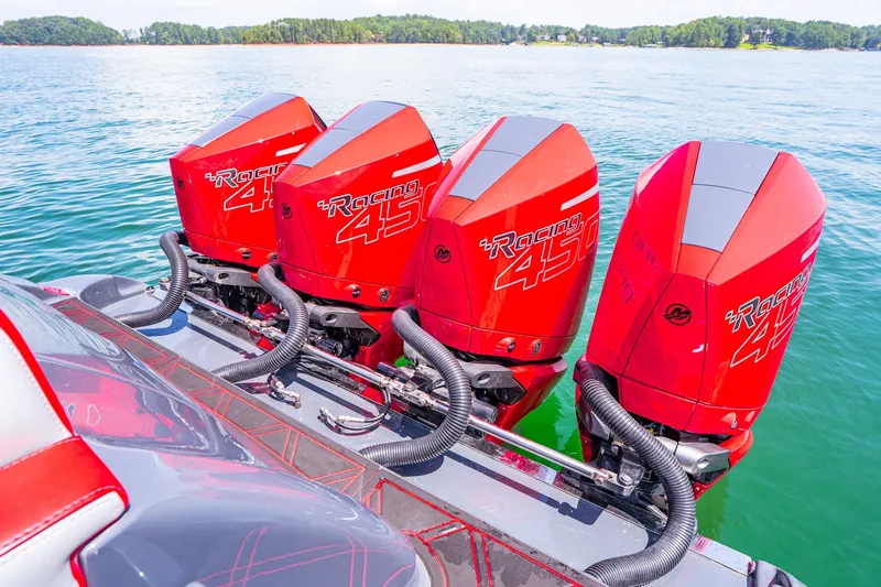 Slide: The Image of Four red Racing 450 outboard motors on a 2022 Deep Impact 399 Sport boat. - 72