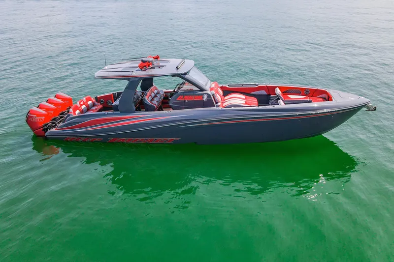 Slide: The Image of 2022 Deep Impact 399 Sport boat with vibrant red accents on calm water. - 13