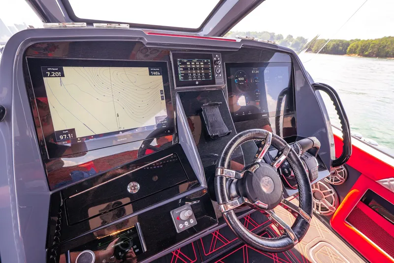 Slide: The Image of Cockpit of 2022 Deep Impact 399 Sport boat with advanced navigation displays and steering wheel. - 48