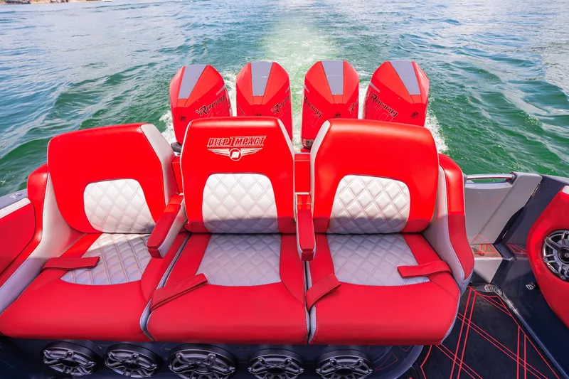Slide: The Image of 2022 Deep Impact 399 Sport boat with red and white seating, powerful engines, cruising on water. - 69
