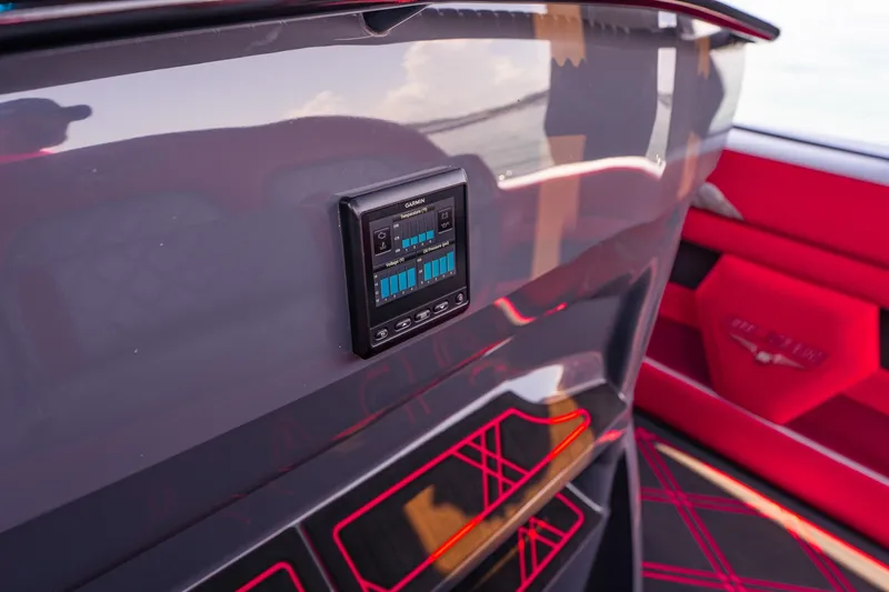 Slide: The Image of Interior of 2022 Deep Impact 399 Sport boat with Garmin display and red accents. - 64