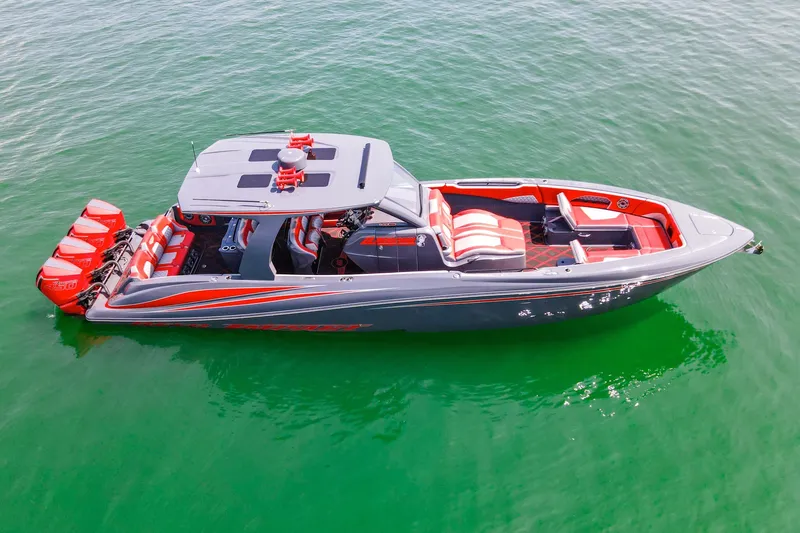 Slide: The Image of 2022 Deep Impact 399 Sport boat with red accents on green water. - 18