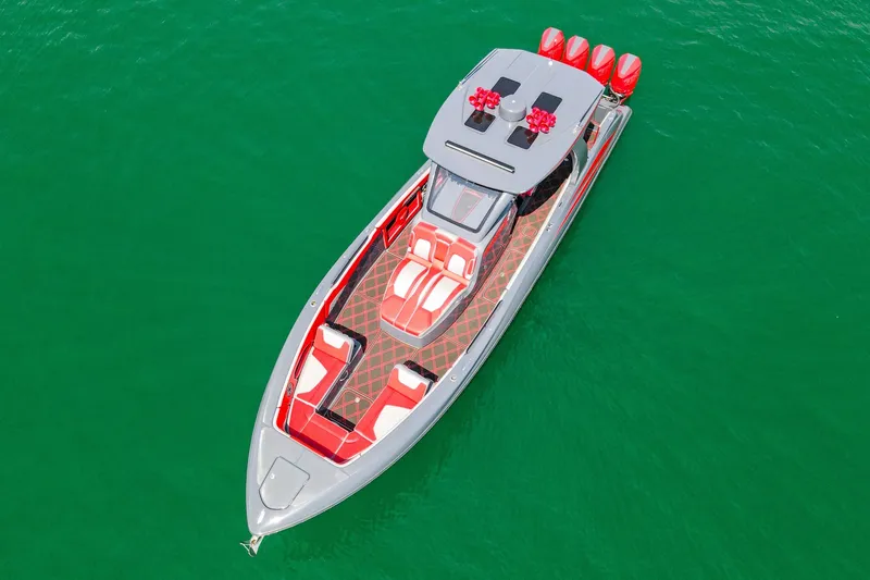 Slide: The Image of 2022 Deep Impact 399 Sport boat with red and white seating on green water. - 24