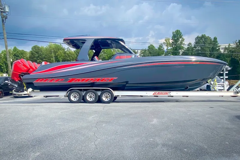 Slide: The Image of 2022 Deep Impact 399 Sport boat on trailer, sleek design, vibrant red accents. - 96