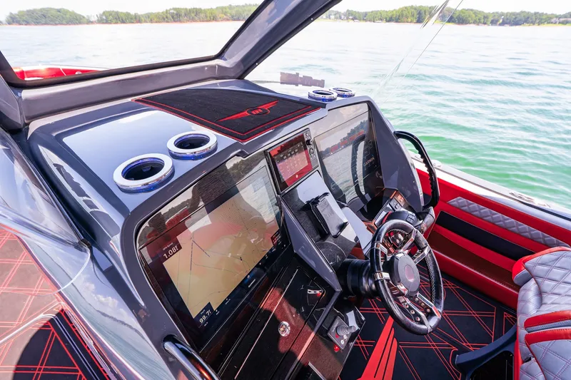 Slide: The Image of Cockpit of 2022 Deep Impact 399 Sport boat with advanced navigation displays. - 50