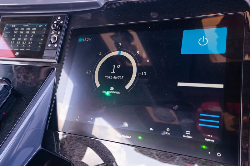 Slide: The Image of Dashboard of 2022 Deep Impact 399 Sport boat showing Seakeeper roll angle display. - 56