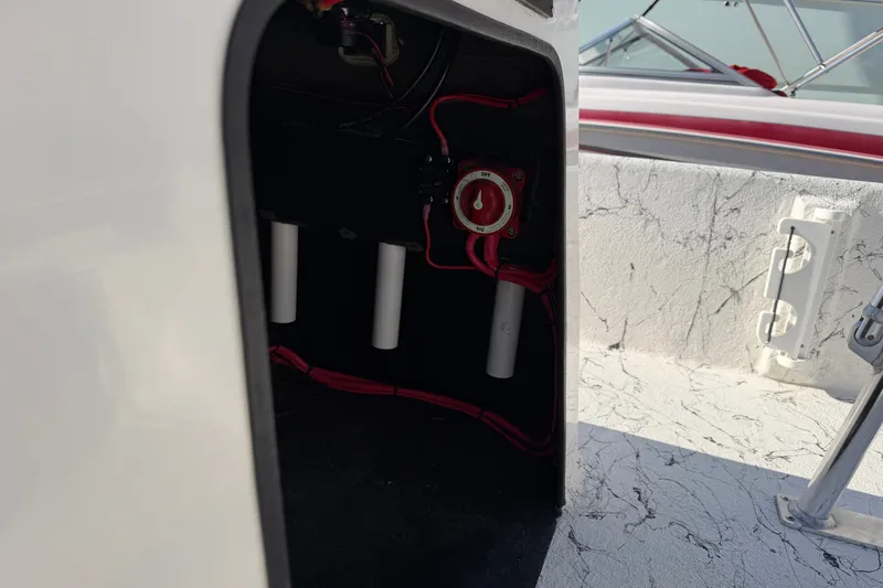 Slide: The Image of Electrical compartment of a 2026 Skuta 21 Tournament V boat, featuring wiring and a power switch. - 28