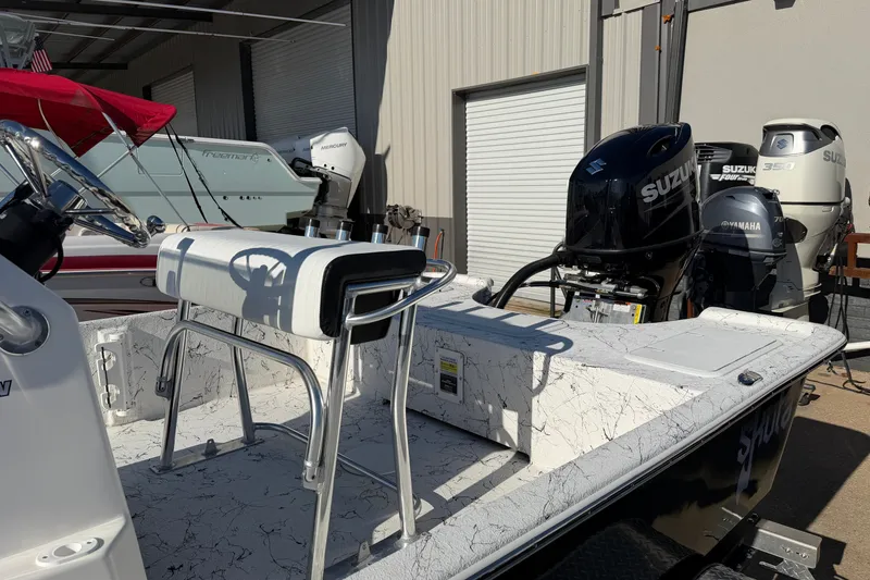 Slide: The Image of 2026 Skuta 21 Tournament V boat with Suzuki outboard motors in a showroom. - 31