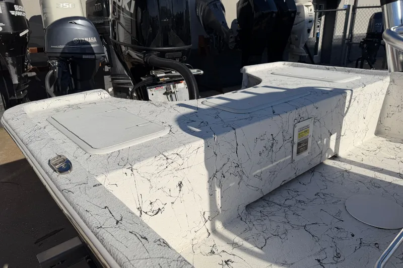 Slide: The Image of 2026 Skuta 21 Tournament V boat deck with marbled design, surrounded by outboard motors. - 37