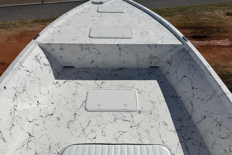 Slide: The Image of 2026 Skuta 21 Tournament V boat deck with marble-like pattern and storage compartments. - 13