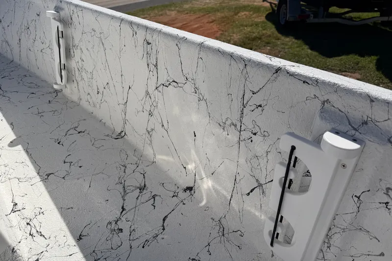 Slide: The Image of Interior view of 2026 Skuta 21 Tournament V boat with marble-like design and rod holders. - 22