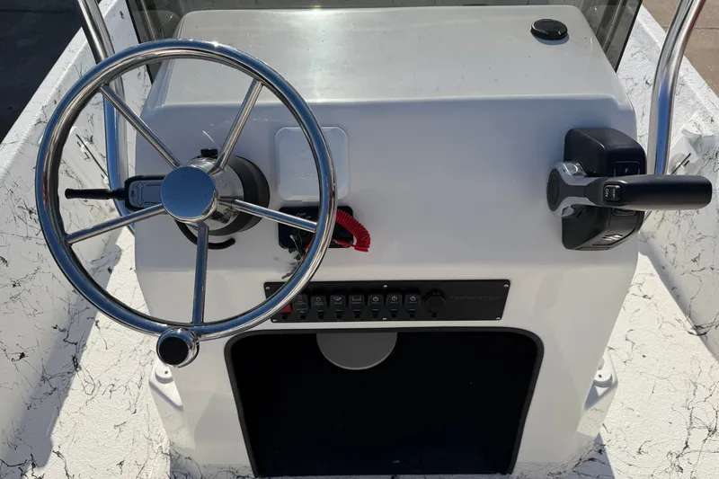 Slide: The Image of Steering console of 2026 Skuta 21 Tournament V boat with controls and switches. - 38