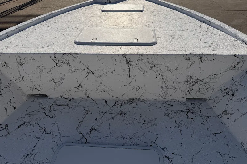 Slide: The Image of 2026 Skuta 21 Tournament V boat deck with textured surface and storage compartments. - 43