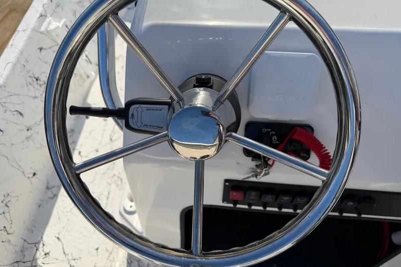 Slide: The Image of Steering wheel of 2026 Skuta 21 Tournament V boat with control panel. - 65