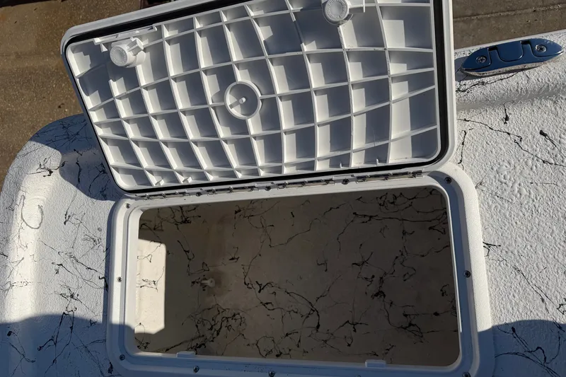 Slide: The Image of Open storage compartment on 2026 Skuta 21 Tournament V boat, featuring a textured interior. - 48