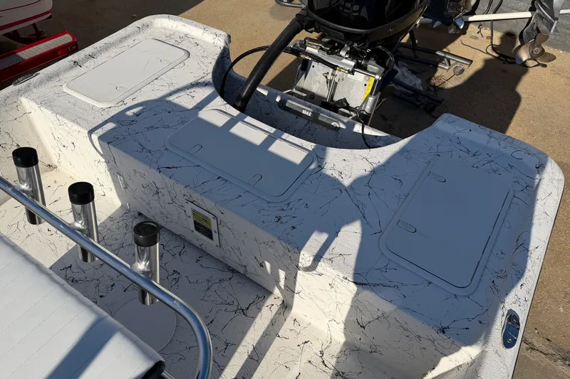 Slide: The Image of 2026 Skuta 21 Tournament V boat deck with storage compartments and motor. - 56