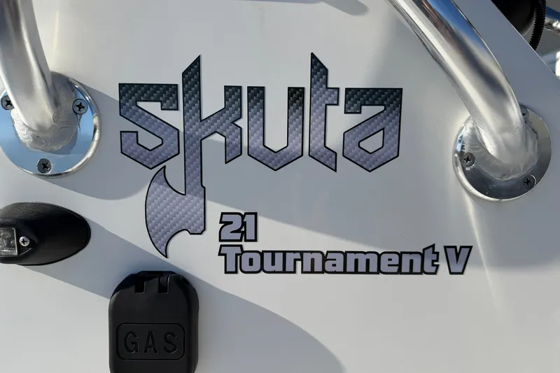 Slide: The Image of Skuta 21 Tournament V 2026 model logo on boat exterior with gas cap. - 29