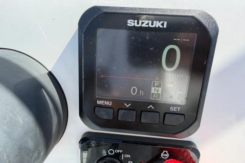 Slide: The Image of Digital display on a 2026 Skuta 21 Tournament V boat, showing Suzuki engine controls. - 24