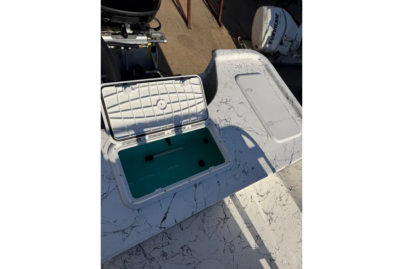 Slide: The Image of Open storage compartment on 2026 Skuta 21 Tournament V boat, showcasing interior details. - 50