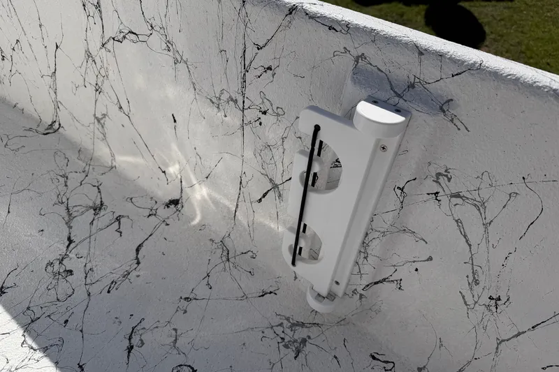 Slide: The Image of Interior detail of 2026 Skuta 21 Tournament V boat with textured white surface and mounted accessory. - 21