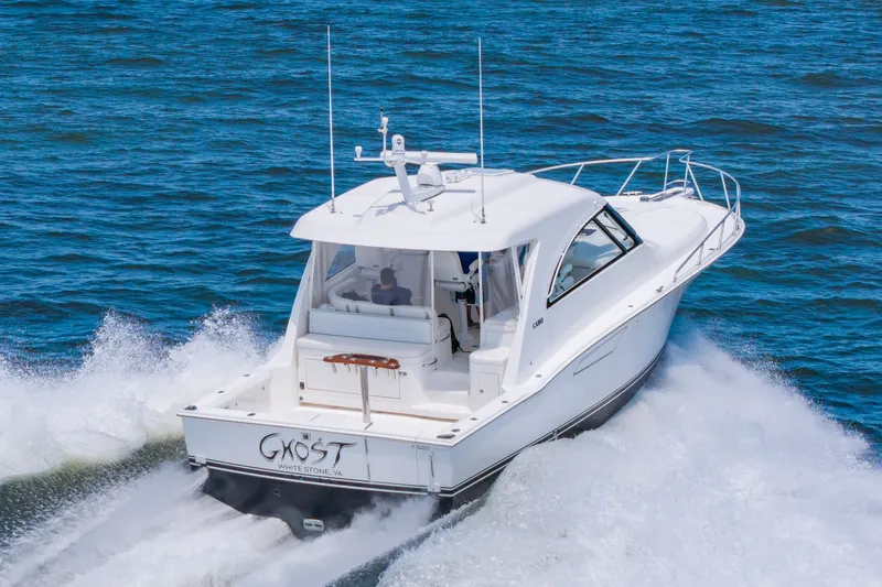 Slide: The Image of 2013 Cabo 40 Hardtop Express cruising on open water, rear view. - 27